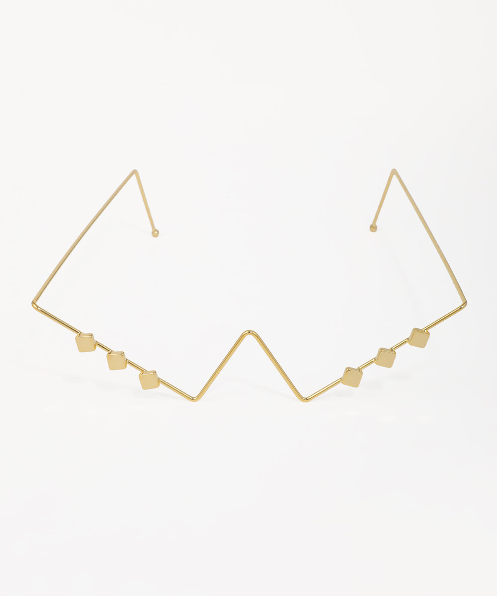 Gold-tone facelet with geometric zig-zag design and small square accents