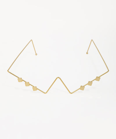 Gold-tone facelet with geometric zig-zag design and small square accents