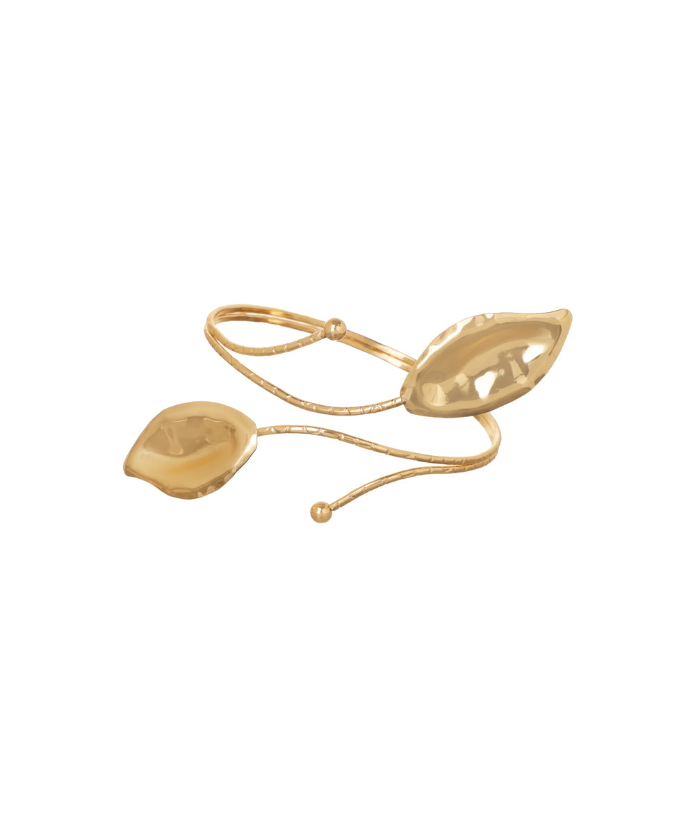 Gold-tone arm cuff with two polished, sculpted leaf accents connected by textured bands.