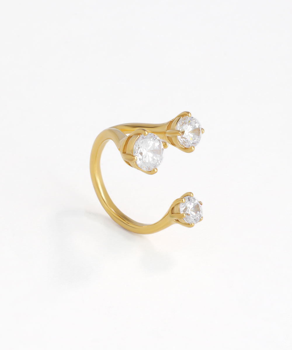 Gold-tone ring with three round clear stones in an open cuff design