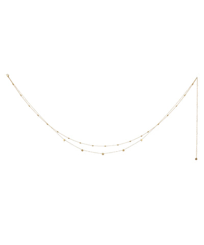 Gold-tone layered waist chain with small star charms and round beads on a delicate chain
