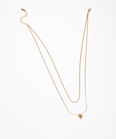 Gold-tone layered necklace with two delicate chains and a small heart pendant