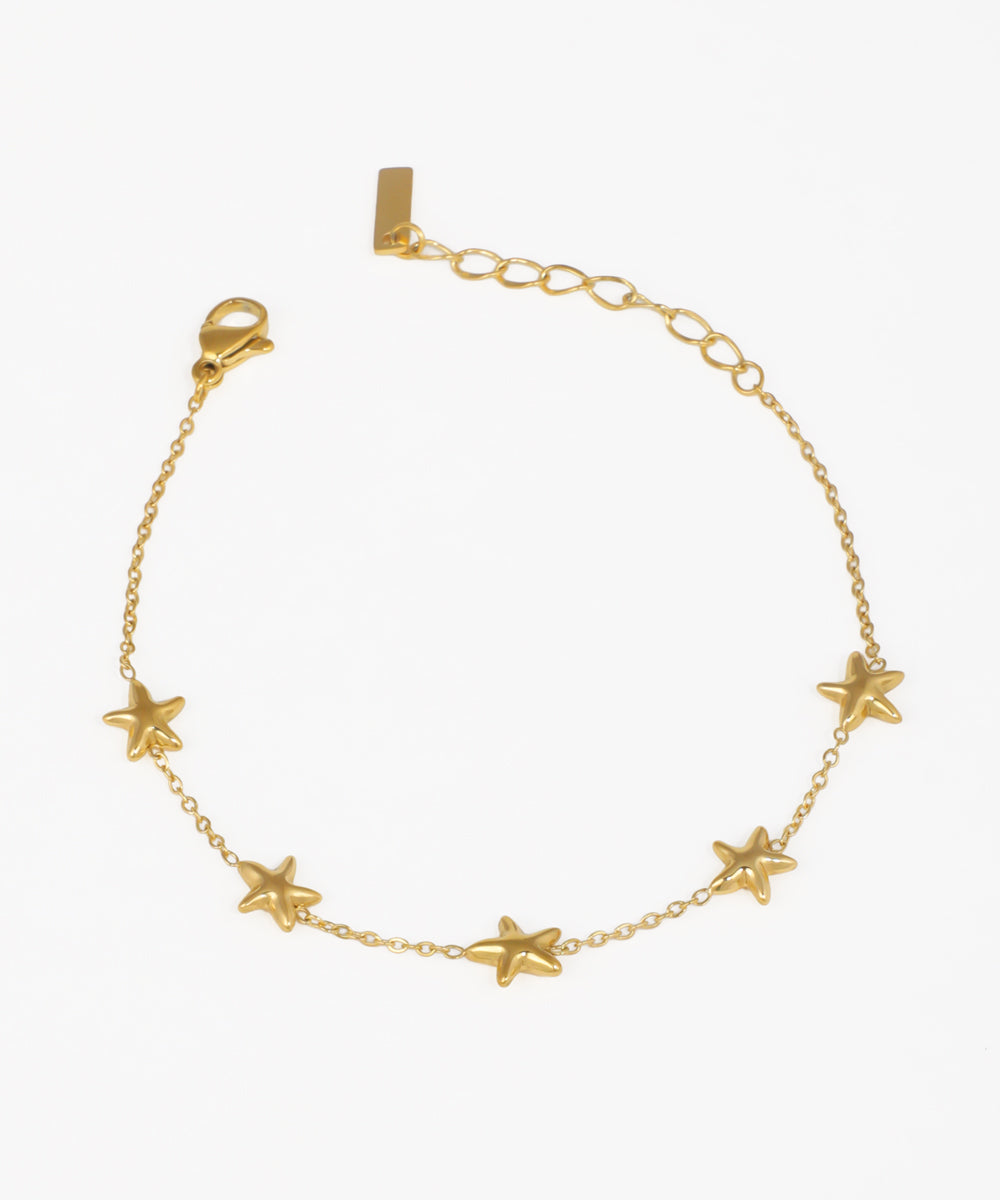 Gold-tone bracelet with small puffed star charms