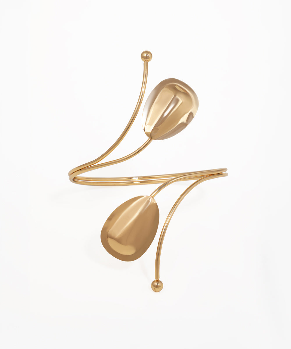 Gold-tone arm cuff with sculptural petal-like elements and wrap-around design