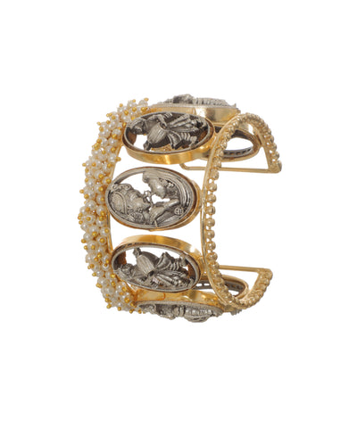 Gold-tone and oxidized cuff bracelet with traditional figurines and faux pearls