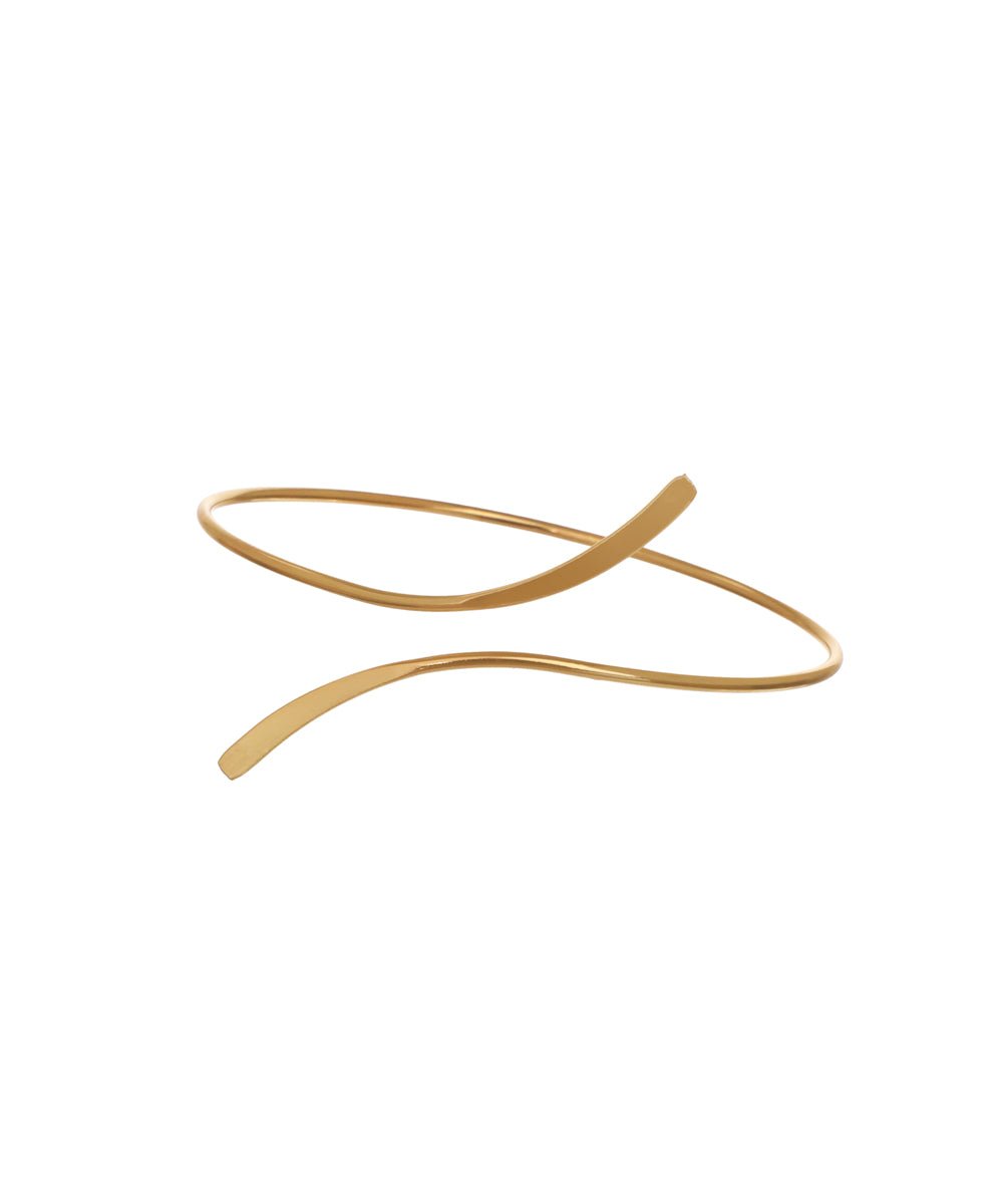 Gold-tone arm cuff with a sleek, wavy abstract design