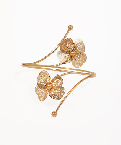 Gold-tone arm cuff with two detailed filigree flowers and an open-ended design