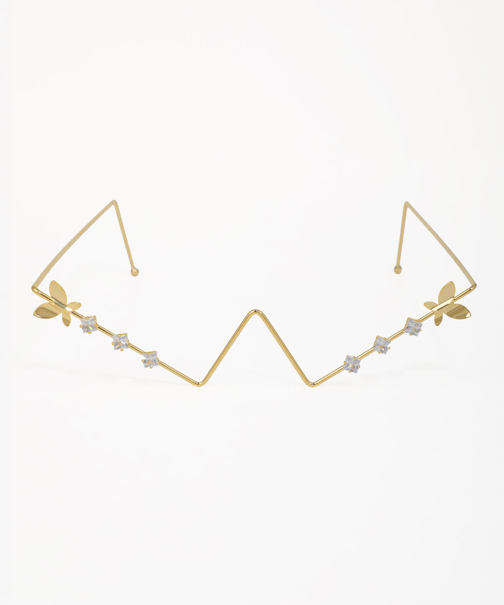 Gold-tone facelet with zig-zag design, butterfly accents, and small clear stones