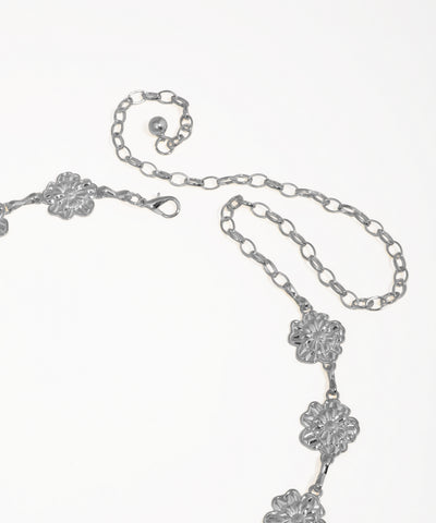 Silver necklace with floral designs on a white background