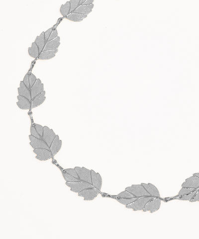 Silver leaf-shaped necklace on a white background