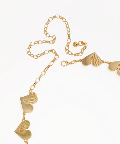 Gold necklace with heart-shaped pendants on a white background