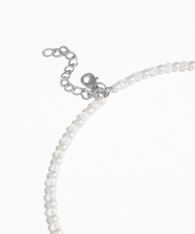 Close-up of a pearl necklace with clasp on a white background