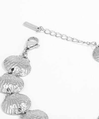 Silver bracelet with shell-shaped charms on a white background