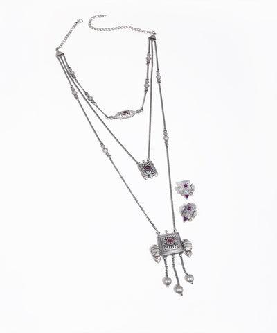Silver necklace with pendant and matching earrings on a white background