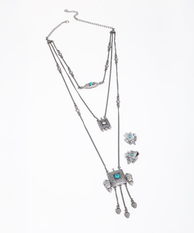 Silver-tone layered necklace with geometric pendants, blue stones, and textured details