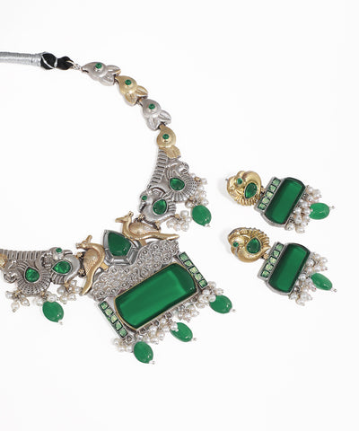 Jewelry set with green stones on a white background