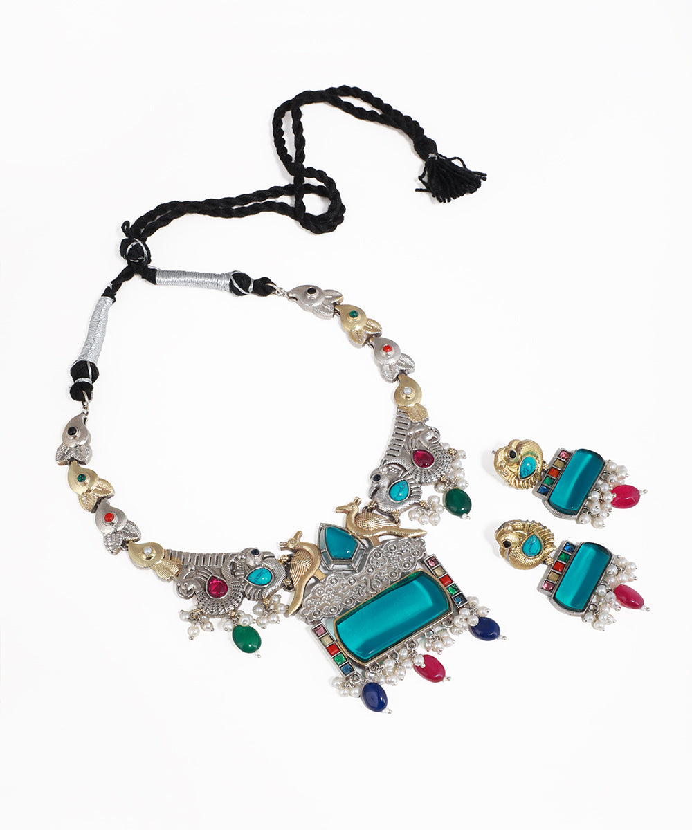 Oxidised silver-tone necklace set with peacock motifs, large teal stones, and multicolor accents