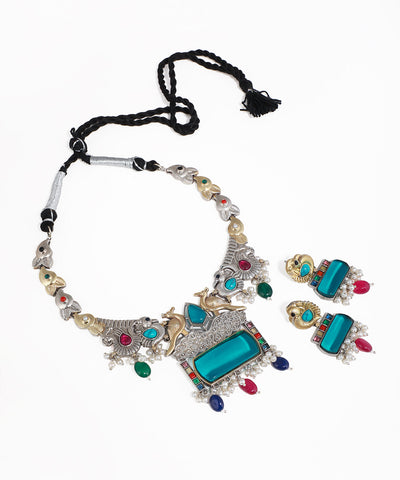 Oxidised silver-tone necklace set with peacock motifs, large teal stones, and multicolor accents