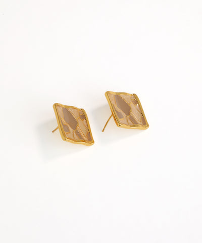 Gold earrings with a brown stone on a white background