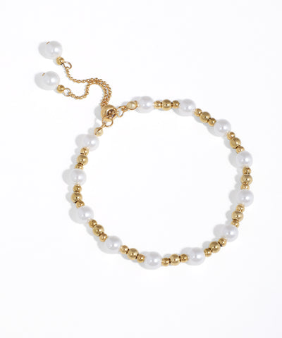 Gold-tone bracelet with alternating white faux pearls and metal beads, featuring an adjustable bolo clasp.