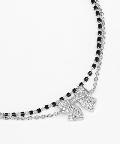 Necklace with a bow-shaped pendant on a white background