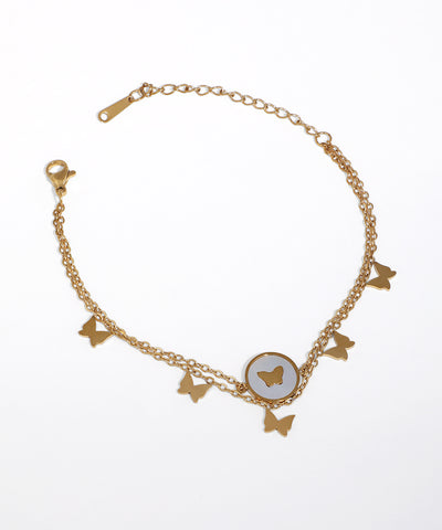 Gold-tone dual chain bracelet with multiple butterfly charms and a central faux pearl butterfly inlay.