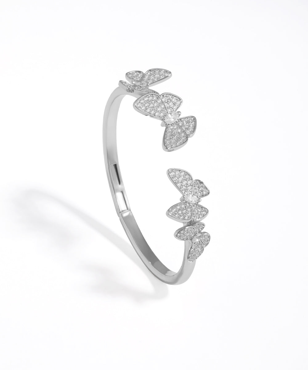 Silver butterfly-shaped bracelet on a white background