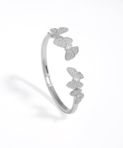 Silver butterfly-shaped bracelet on a white background