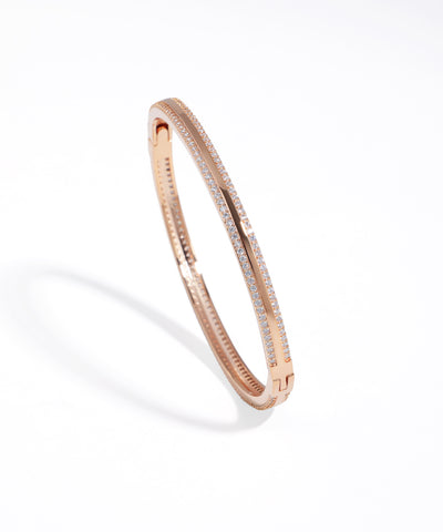 Rose gold bracelet with small diamonds on a white background