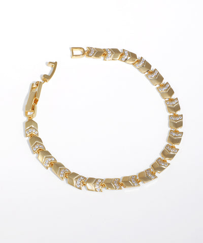 Gold-tone chevron link bracelet with clear CZ accents and a box clasp closure