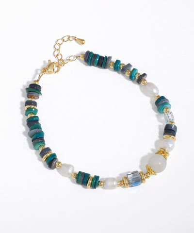 Gold-tone bracelet with varied teal, grey, and white beads, faux pearls, and clear glass crystals.