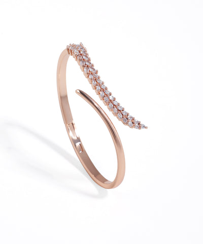 Rose gold bracelet with diamond accents on a white background