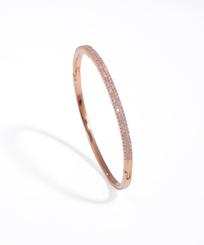 Rose gold bracelet with small stones on a white background
