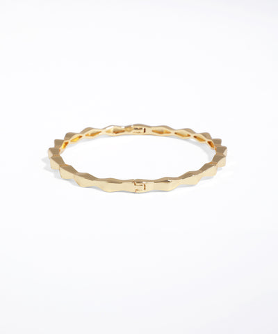 Gold ring with a textured band on a white background