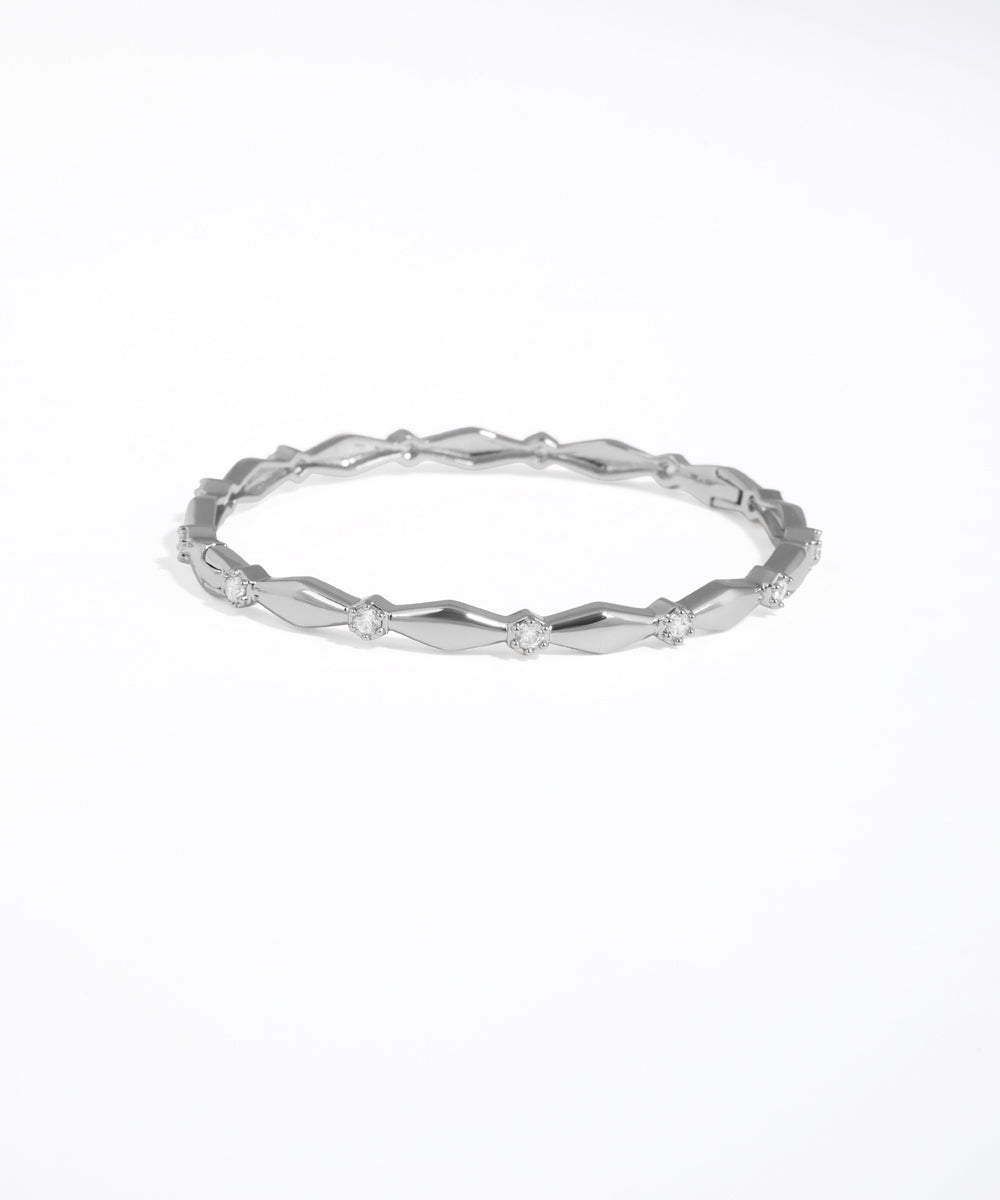 Silver ring with a textured band on a white background