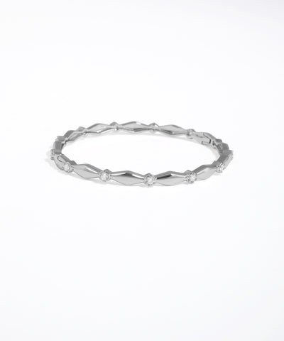 Silver ring with a textured band on a white background