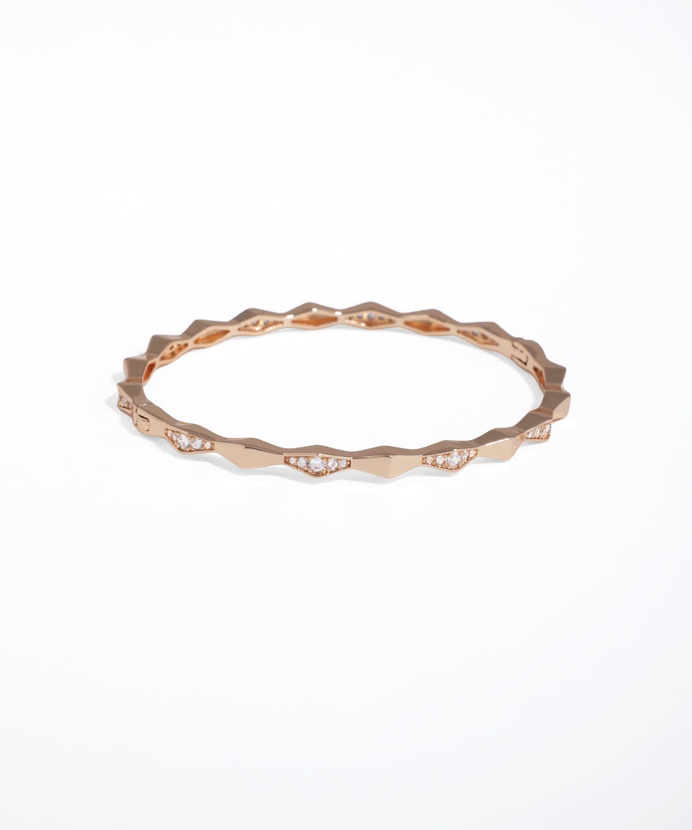 Rose gold ring with small diamonds on a white background