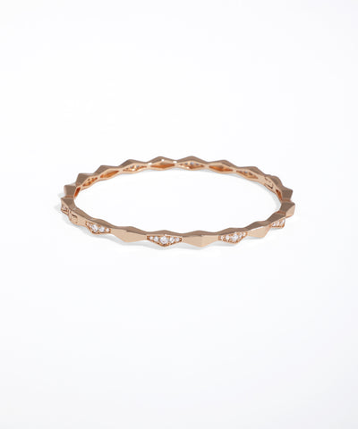 Rose gold ring with small diamonds on a white background