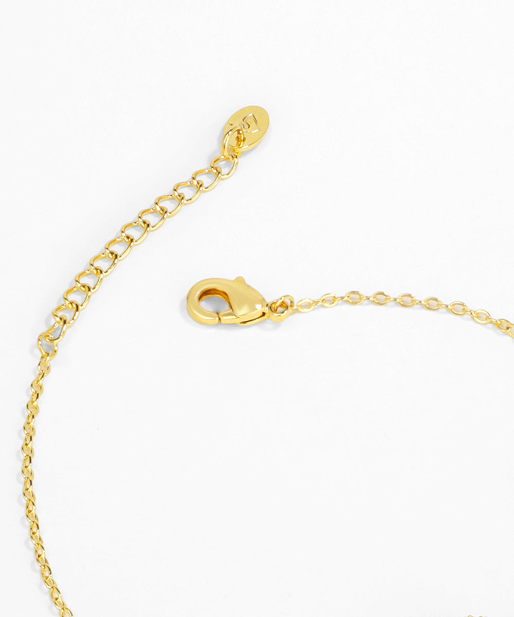 Gold bracelet with clasp on a white background