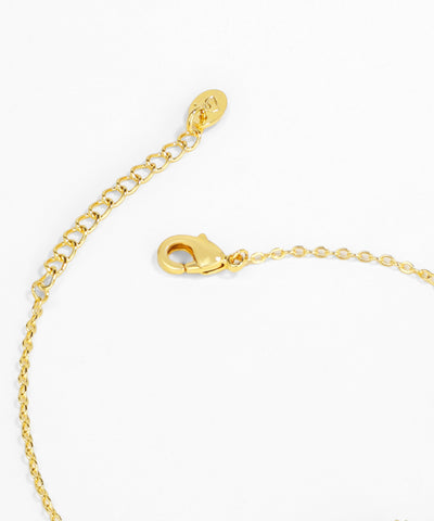 Gold bracelet with clasp on a white background