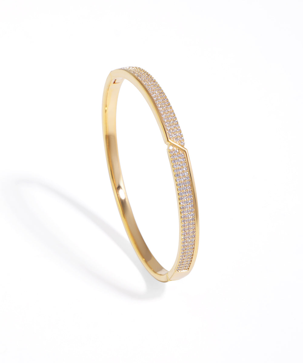 Gold-tone bracelet with pave set cubic zirconia stones in a diagonal geometric pattern