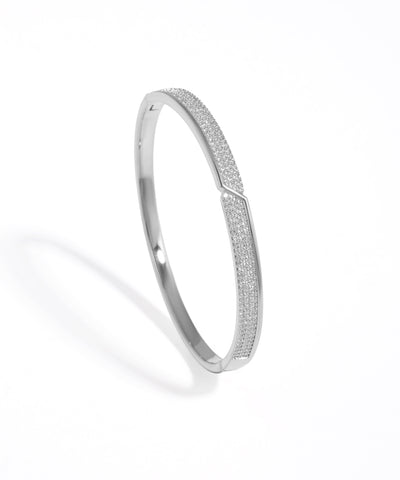 Silver bracelet with textured design on a white background