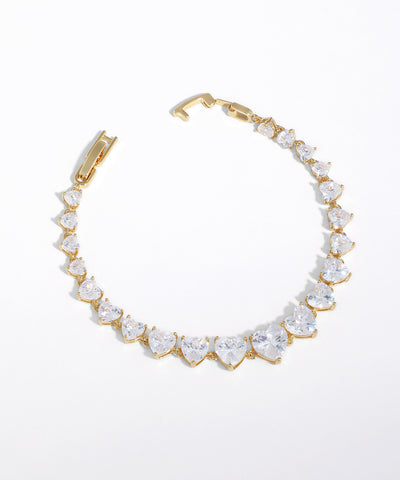 Gold-tone bracelet with graduated heart-shaped clear stones