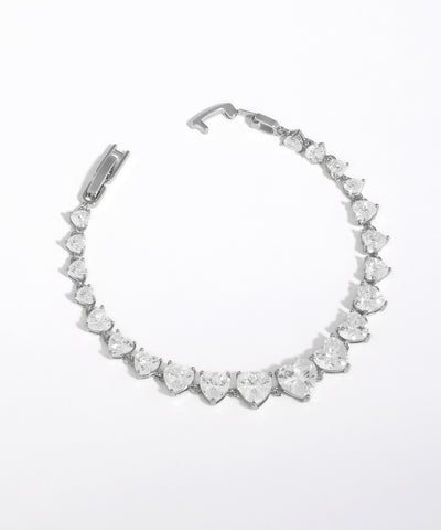 Silver bracelet with heart-shaped crystals on a white background