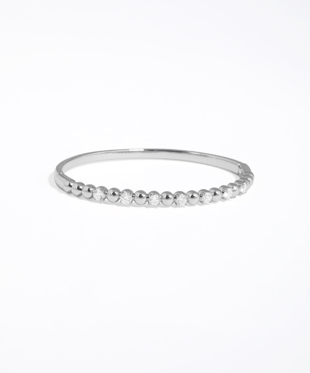 Silver beaded ring on a white background