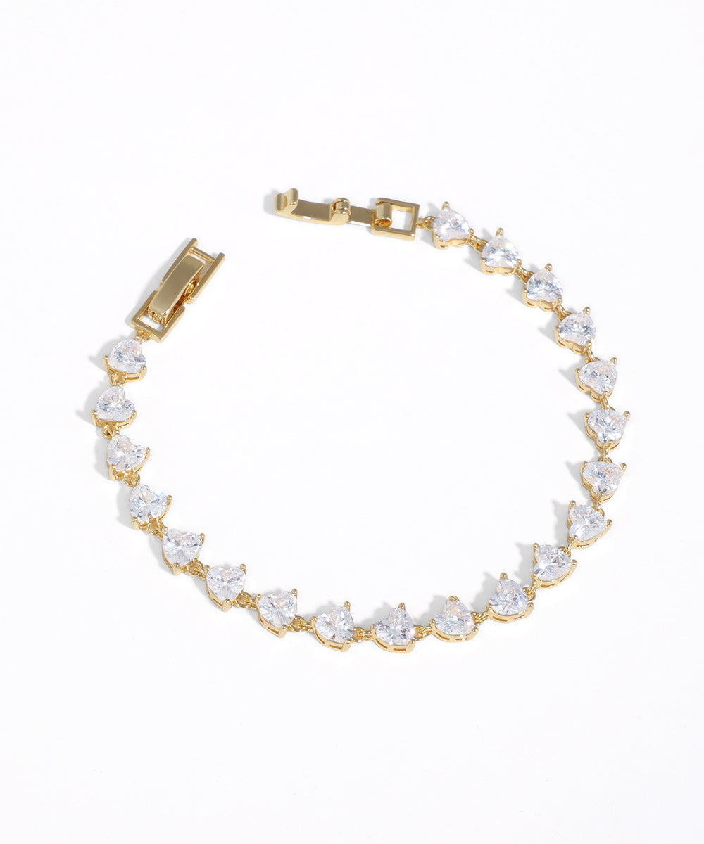 Gold-tone bracelet with continuous heart-cut CZ stones