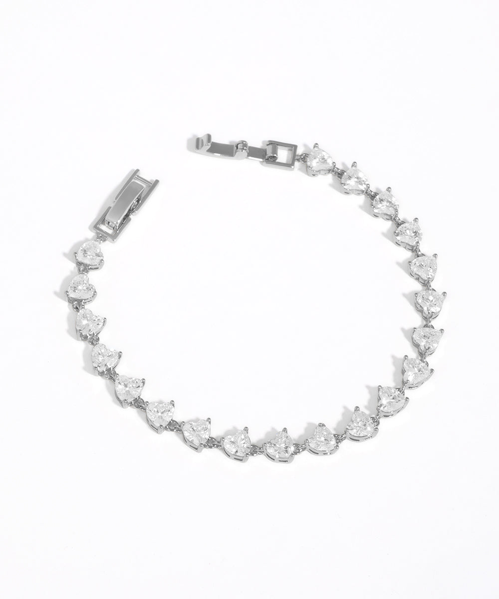 Silver bracelet with clear gemstones on a white background