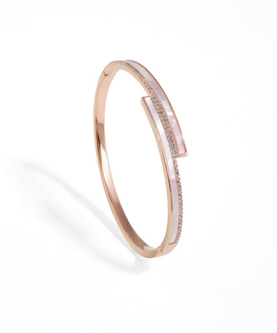 Rose gold bracelet with diamond accents on a white background