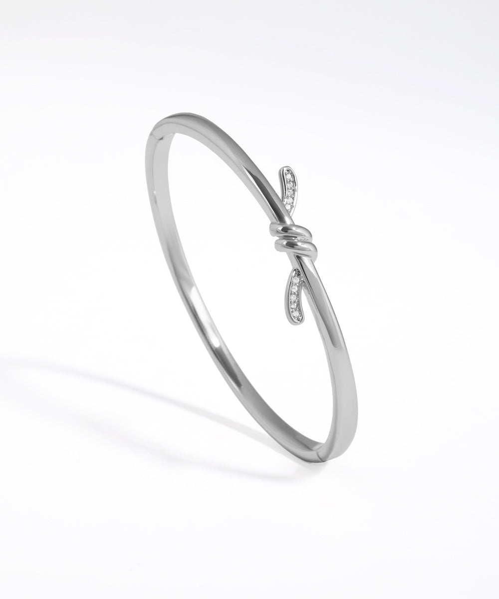 Silver bracelet with a subtle design on a white background