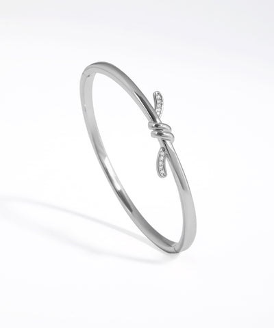 Silver bracelet with a subtle design on a white background